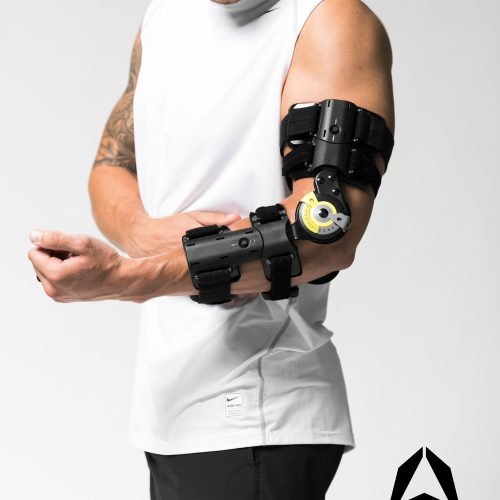 A man with a TRU-RANGE® POST-OP ELBOW brace on his arm.