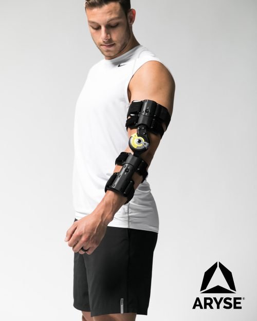 A man wearing a TRU-RANGE® POST-OP ELBOW brace.