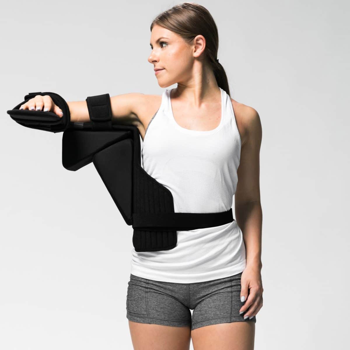 A woman wearing an ARYSE TRU-RANGE SHOULDER brace seeks medical supply.