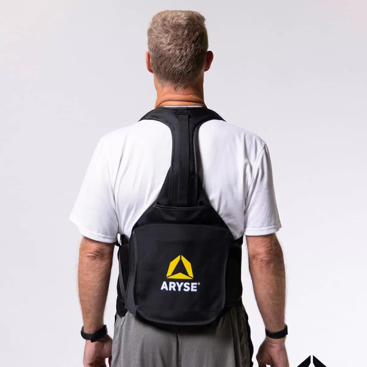 The back of a man wearing a METFORCE® TLSO backpack with the word ayce on it.