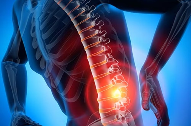 Illustration of a human spine with a highlighted red region indicating pain in the lower back area, provided by Artik Med. The surrounding skeleton structure is also visible against a blue background.